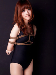 Lala Asian babe in bath suit has hands tied of her boobs in ropes - Japarn porn pics at JapHole.com
