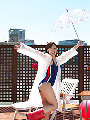Kana Yuuki Asian in bath suit plays with umbrella in the balcony - Japarn porn pics at JapHole.com